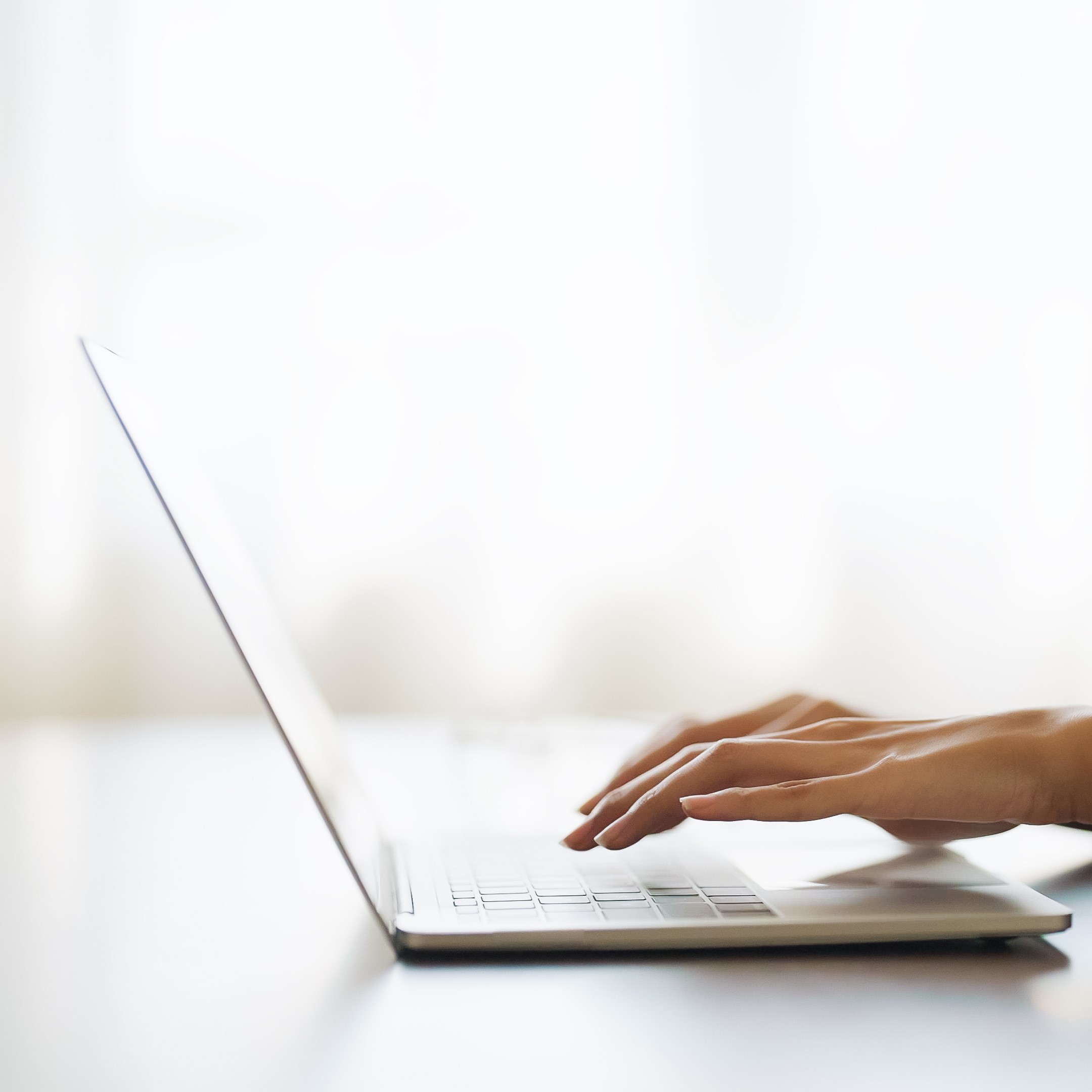 A woman searching on her laptop for "Free Parenting Classes in Toledo, Ohio"