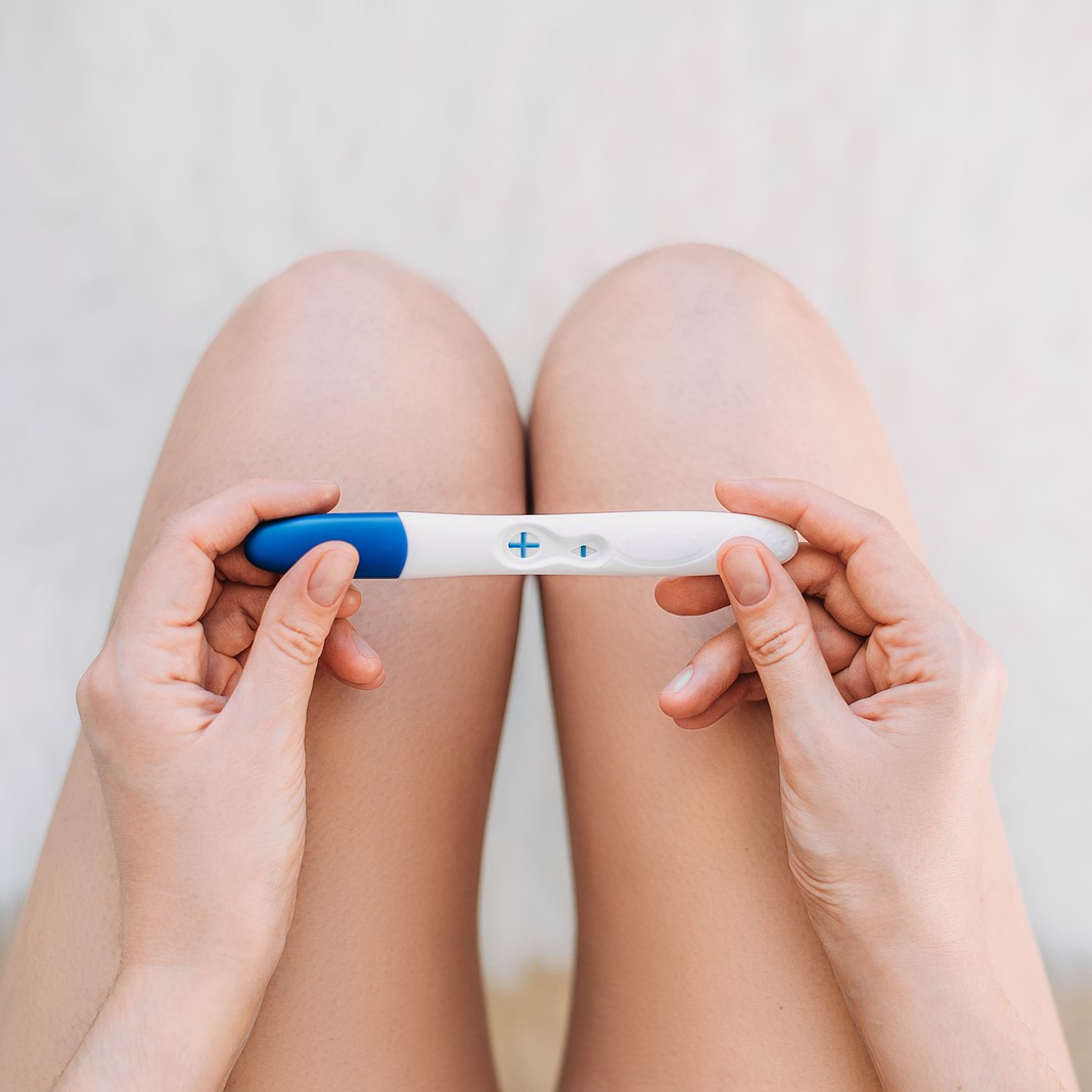 A woman holding a free pregnancy test in Toledo, Ohio